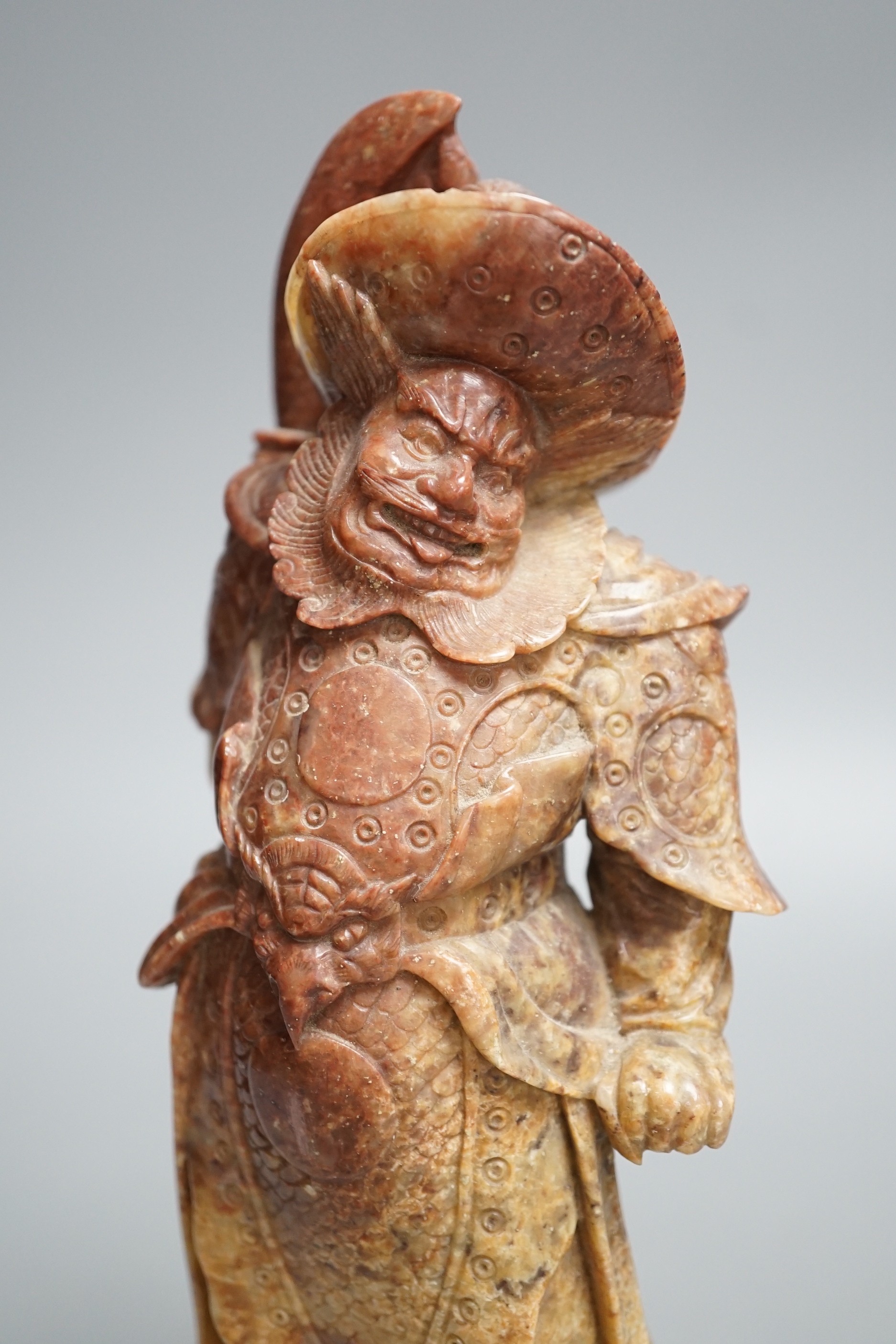 An early 20th century Chinese soapstone carving of Zhong Kui, 30cm high.